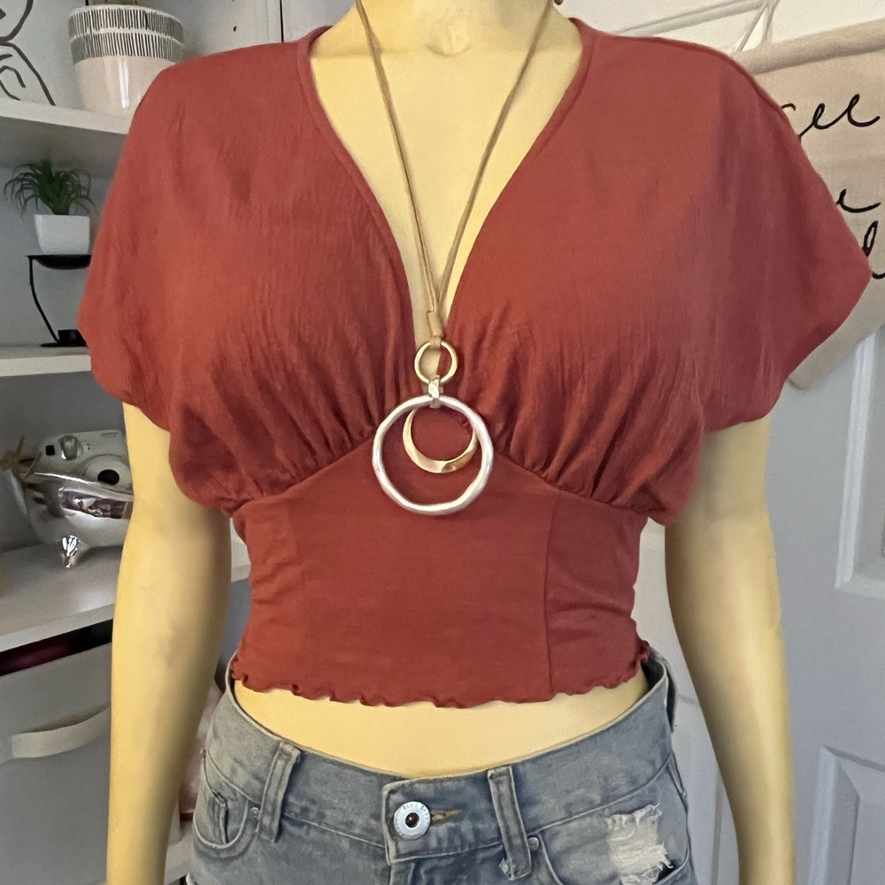 A maroon, red-ish blouse top.